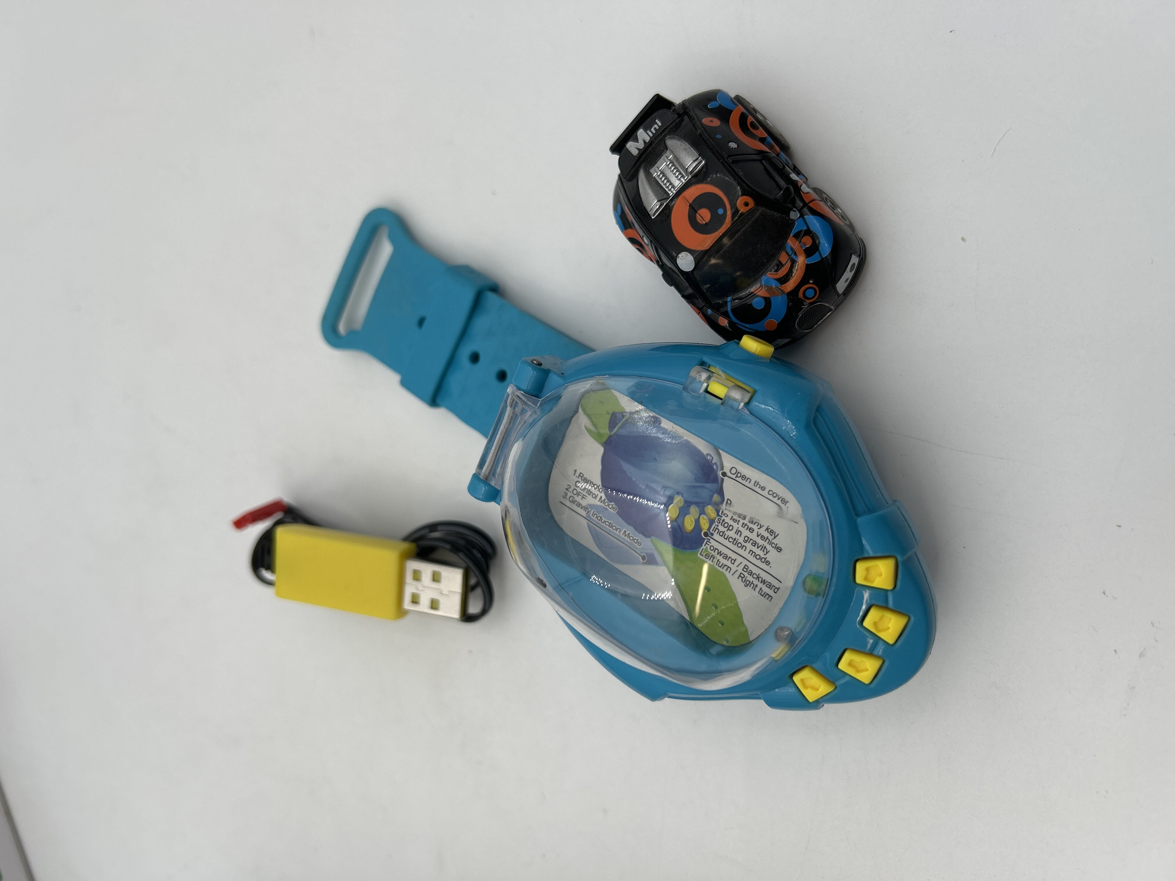 Billede fra myndighedens meddelelse af det tilbagekaldte produkt Children Boys Gift Cartoon Mini RC Remote Control Car Watch. Årsag: OVERTRÆD.