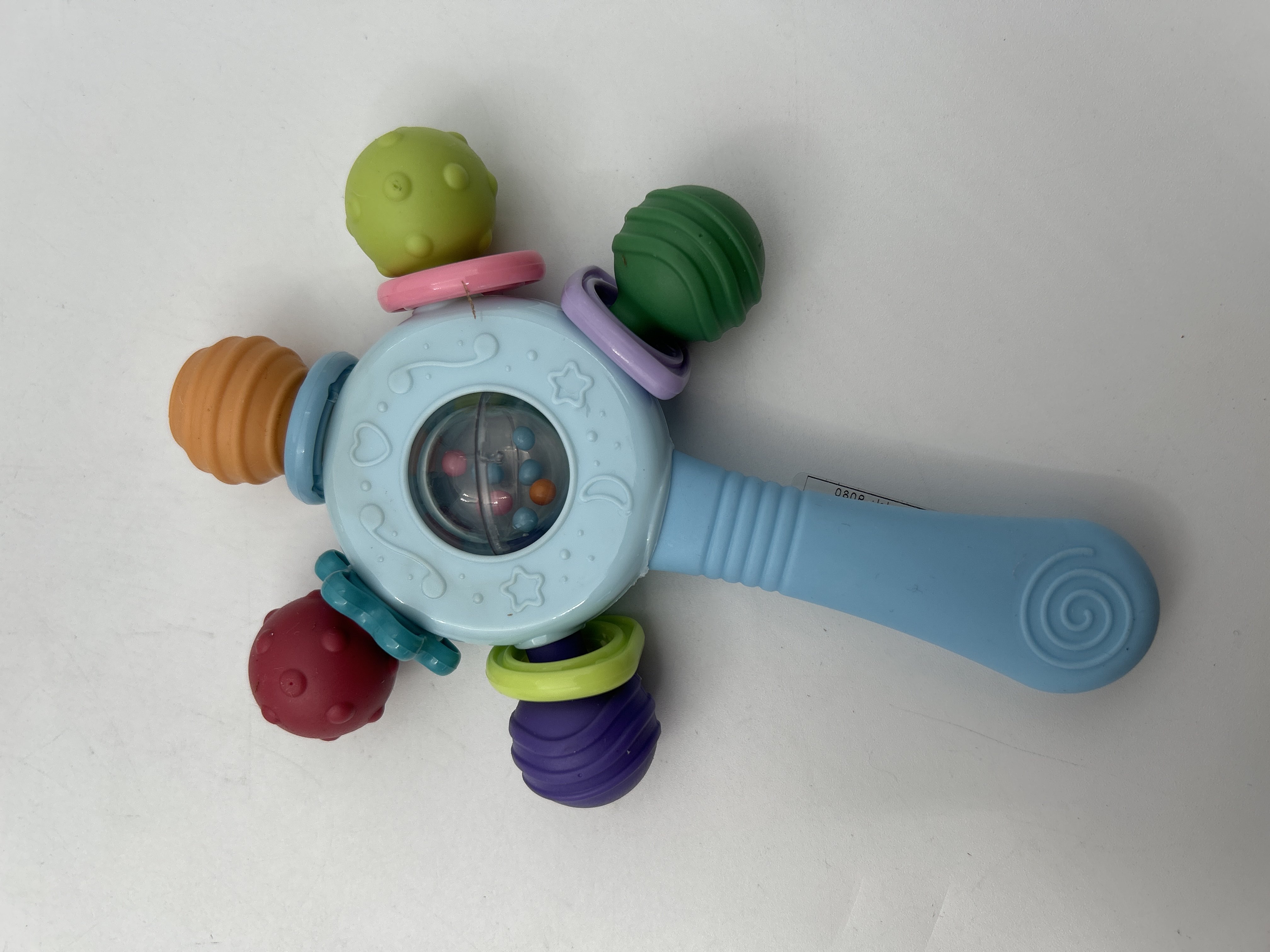 Billede fra myndighedens meddelelse af det tilbagekaldte produkt Manhattan Teether Rattle. Årsag: OVERTRÆD.